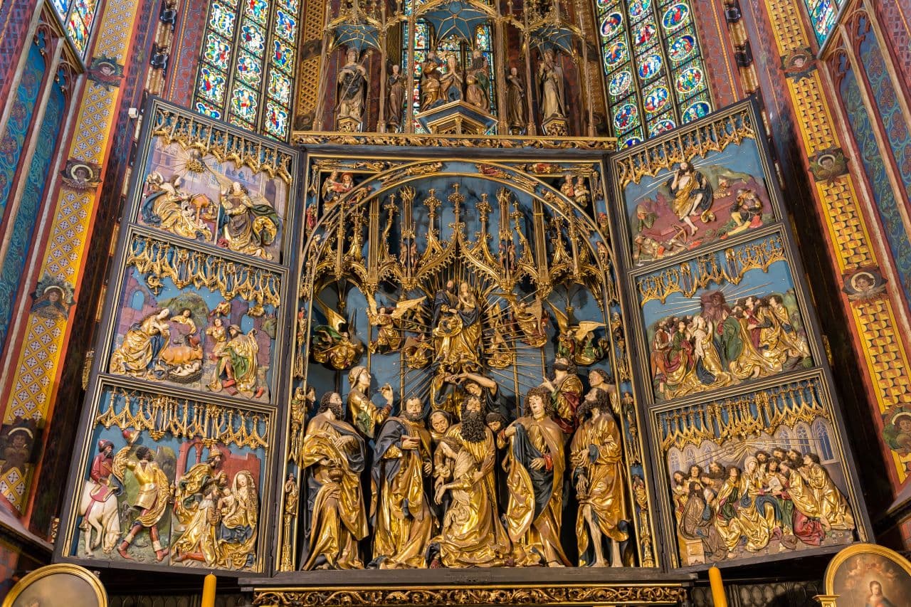 Detailed cathedral altarpiece featuring religious figures and vibrant artwork.